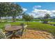 Patio with table and chairs overlooking a pond at 120 Trailwood Dr, Leesburg, FL 34748