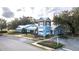 Community building with a charming design and ample parking at 10593 Grand Oaks Blvd, Oxford, FL 34484
