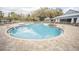 Large freeform community pool with plenty of deck space at 10593 Grand Oaks Blvd, Oxford, FL 34484