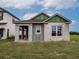 Newly constructed single-story home with block exterior and covered porch at 10593 Grand Oaks Blvd, Oxford, FL 34484