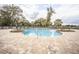 Inviting kidney-shaped pool surrounded by a spacious patio at 10593 Grand Oaks Blvd, Oxford, FL 34484
