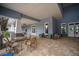 Covered patio area with comfortable seating near the pool at 10607 Grand Oaks Blvd, Oxford, FL 34484