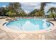 Inviting community pool with plenty of lounge chairs at 10607 Grand Oaks Blvd, Oxford, FL 34484