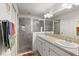 Clean bathroom, double vanity, and a walk-in shower at 2968 Wotring Way, The Villages, FL 32163
