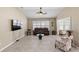 Spacious living room with a leather sofa and tile flooring at 2968 Wotring Way, The Villages, FL 32163