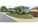 Landscaped front yard with a circular driveway at 2968 Wotring Way, The Villages, FL 32163