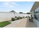 Small backyard patio with landscaping and a bench at 2968 Wotring Way, The Villages, FL 32163