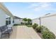Landscaped backyard with a patio and a bench at 2968 Wotring Way, The Villages, FL 32163