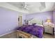 Spacious bedroom with king-size bed and ensuite bathroom access at 2968 Wotring Way, The Villages, FL 32163