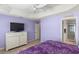 Bedroom with TV, dresser, and access to bathroom at 2968 Wotring Way, The Villages, FL 32163