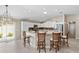 Spacious kitchen with white cabinets, an island, and stainless steel appliances at 2968 Wotring Way, The Villages, FL 32163