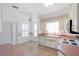 Kitchen with white cabinets, laminate flooring, and a breakfast nook at 21701 Queen Mary Ct, Leesburg, FL 34748