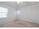 Simple bedroom with carpet flooring, window, and ceiling fan at 21701 Queen Mary Ct, Leesburg, FL 34748