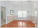 Dining room with hardwood floors and chandelier at 21701 Queen Mary Ct, Leesburg, FL 34748