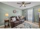Cozy sitting room featuring a brown leather couch and a window with curtains at 15300 Sw 14Th Avenue Rd, Ocala, FL 34473