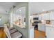 Modern kitchen with white cabinetry, stainless steel appliances, and a breakfast bar at 15300 Sw 14Th Avenue Rd, Ocala, FL 34473