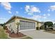 Attached garage with a screened enclosure, and landscaping at 15300 Sw 14Th Avenue Rd, Ocala, FL 34473