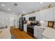 Clean and bright kitchen with white cabinets and stainless steel appliances at 15300 Sw 14Th Avenue Rd, Ocala, FL 34473
