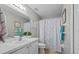 Clean bathroom with a shower/tub combo, white vanity, and neutral decor at 15300 Sw 14Th Avenue Rd, Ocala, FL 34473