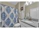 Clean bathroom with shower, granite countertop, and white vanity at 1592 Flange Dr, Davenport, FL 33896