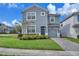 Two-story house with gray siding and a two-car garage at 1592 Flange Dr, Davenport, FL 33896
