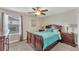 Bedroom with queen bed and ceiling fan at 1592 Flange Dr, Davenport, FL 33896