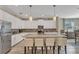 Modern kitchen with granite island, white cabinets, and stainless steel appliances at 1592 Flange Dr, Davenport, FL 33896