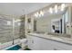 Bathroom with granite countertops, double sinks, and a walk-in shower at 1592 Flange Dr, Davenport, FL 33896