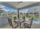 Relaxing screened patio with table and chairs overlooking the pool at 1592 Flange Dr, Davenport, FL 33896