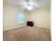 Spacious bedroom featuring a window, ceiling fan, and a desk at 5430 Sir Churchill Dr, Leesburg, FL 34748