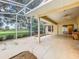 Spacious covered patio with screened enclosure and backyard access at 5430 Sir Churchill Dr, Leesburg, FL 34748