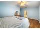 Spacious bedroom with light blue walls, ceiling fan, and wood-look flooring at 5430 Sir Churchill Dr, Leesburg, FL 34748