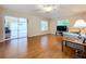 Living room with hardwood floors, sliding doors to a patio, and a cozy sitting area at 5430 Sir Churchill Dr, Leesburg, FL 34748