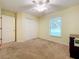 Well-lit bedroom with double door closet, window, and ceiling fan at 5430 Sir Churchill Dr, Leesburg, FL 34748