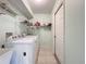 Laundry room with washer, dryer, and storage shelving at 5430 Sir Churchill Dr, Leesburg, FL 34748