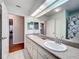 Double vanity bathroom with access to another room and a shower at 5430 Sir Churchill Dr, Leesburg, FL 34748