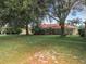 Mature trees and green lawn in spacious backyard at 5430 Sir Churchill Dr, Leesburg, FL 34748