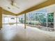 Covered patio with screened enclosure, ceiling fan, and view of backyard at 5430 Sir Churchill Dr, Leesburg, FL 34748