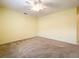 Well-lit bedroom with ceiling fan and neutral carpeting at 5430 Sir Churchill Dr, Leesburg, FL 34748