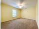 Spacious bedroom with neutral walls, ceiling fan and carpeting at 5430 Sir Churchill Dr, Leesburg, FL 34748