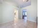 Bright bonus room with tile floors and views of the kitchen and living room at 5430 Sir Churchill Dr, Leesburg, FL 34748