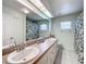 Bathroom boasts double sinks, a shower, and an extended mirror at 5430 Sir Churchill Dr, Leesburg, FL 34748