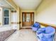 Covered front porch with two blue chairs at 5430 Sir Churchill Dr, Leesburg, FL 34748