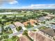 Aerial view of community, showcasing homes and a lake at 5430 Sir Churchill Dr, Leesburg, FL 34748
