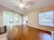 Living room with hardwood floors, sliding glass doors, and a window with blinds at 5430 Sir Churchill Dr, Leesburg, FL 34748