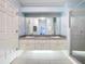 Elegant bathroom with double vanity, granite counters, and large shower at 5430 Sir Churchill Dr, Leesburg, FL 34748