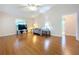 Spacious living room with hardwood floors, a sofa, and access to a bathroom at 5430 Sir Churchill Dr, Leesburg, FL 34748