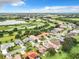 Aerial view of neighborhood with lake and lush greenery at 5430 Sir Churchill Dr, Leesburg, FL 34748