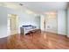 Bright living room with hardwood floors and access to other rooms at 5430 Sir Churchill Dr, Leesburg, FL 34748