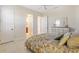 Bedroom with a queen-size bed, dresser and ensuite bathroom access at 871 Iron Oak Way, The Villages, FL 32163